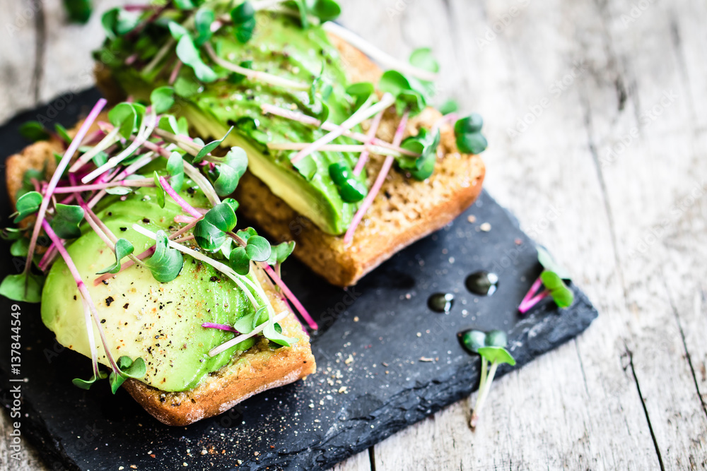 Delicious vegan sandwich with avocado and radish cress - obrazy, fototapety, plakaty 