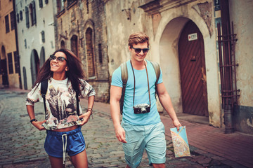 Wall Mural - Multi ethnic tourists couple with map in old city