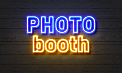 Wall Mural - Photo booth neon sign on brick wall background.