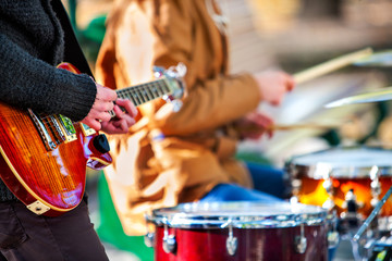 festival music band. hands playing on percussion instruments in city park . drums with sticks closeu