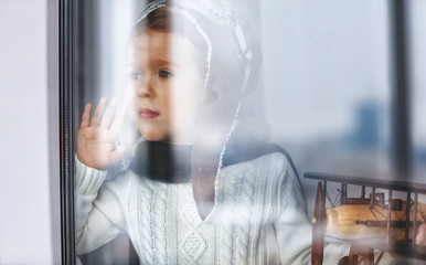 Wall Mural - child baby pilot at window with toy airplane.