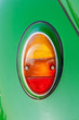 Close-up tail lamp of classic beetle green the popular German car manufacture.