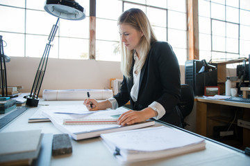 Wall Mural - Creative designer architect drafting designing creating focused determined at workspace cubicle