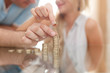 © sakkmesterke - Young couple building money column on glass desk