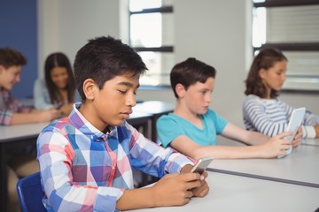 Wall Mural - Students with digital tablet and mobile phone in classroom