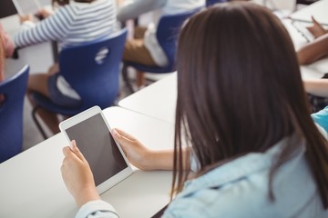 Wall Mural - Student using digital tablet in classroom