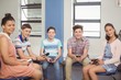 © WavebreakMediaMicro - Students holding mobile phone in classroom