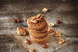 Crispy cookies with cocoa and nuts, dark wood background, selective focus