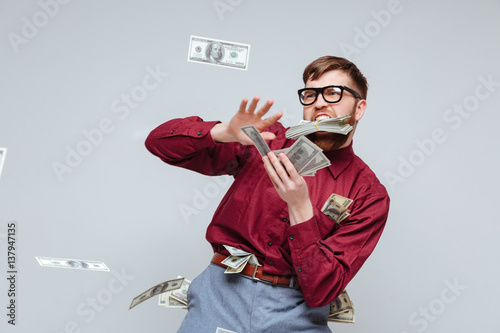 Fotografía Happy Male nerd playing with money