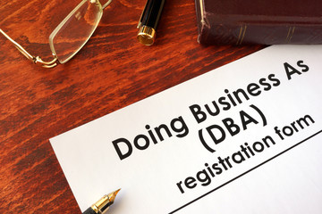 DBA Registration doing business as form on a table.