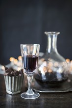 Port Wine In A Glass And A Carafe With Chocolate Pralines