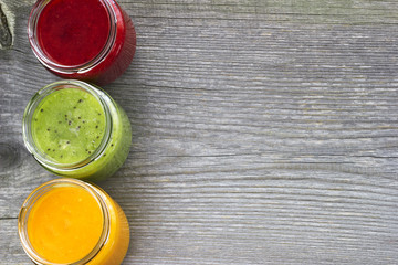 Refreshing fruit smoothie on grey table