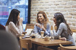 © LUMINA IMAGES - Three beautiful young Caucasian woman chatting at coffee shop.