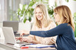 © sepy - Teamwork in the office. Shot of two financial businesswomen working together in the office and consulting about business report.