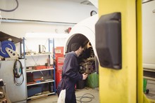 Mechanic Examining A Car Wheel Disc Brake
