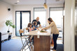 © Cavan Images - Family preparing food in the kitchen counter at home