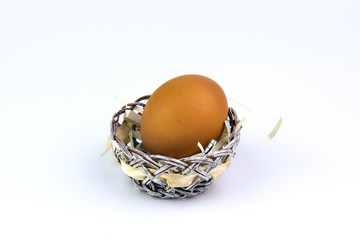 Chicken egg in a basket on a white background