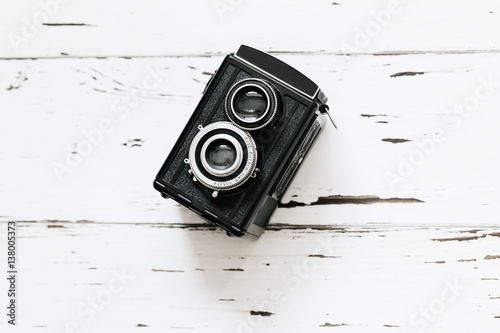 Stampe Retro medium format camera on wood table background, vintage concept