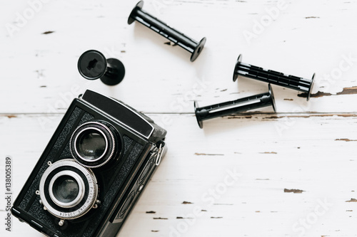 Stampa su Tela Retro medium format camera on wood table background, vintage concept