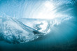 © Cavan Images - Low angle view of surfboard in sea