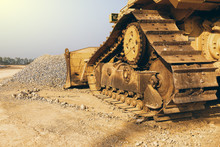 Construction Caterpillar Tractor Working With Pile Of Gravel And Sky