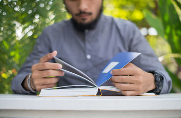 Wall Mural - Young hipster beard man reading books in home garden with nature. Education concept.