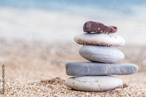 Naklejka - mata magnetyczna na lodówkę Pile of stacked stones on the sandy beach at Adriatic sea