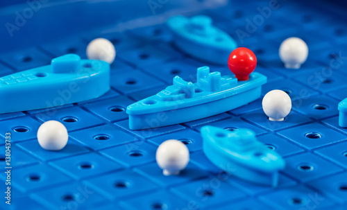 Fotografía Toy war ships and submarine are placed on the blue playing Board