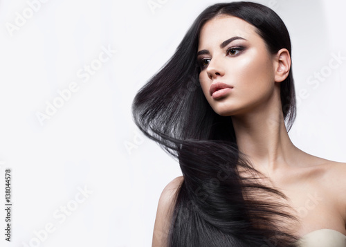 Beautiful brunette girl in move with a perfectly smooth hair, and classic make-up Canvas Print