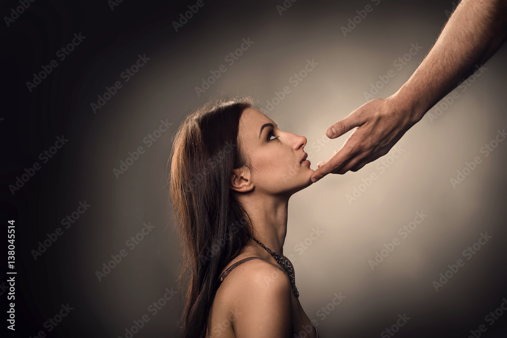 Male hand touches to woman face as Sexual Harassment - obrazy, fototapety, plakaty 