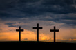 Jesus Christ cross between two crosses on Golgota Mountain, on  blue, orange, purple sky with dramatic clouds,light,sunset, twilight, dusk. Easter, Crucifixion, resurrection, Good Friday concept 