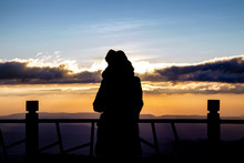 Silhouette Of A Beautiful Woman Standing On Panoramic Viewpoint., Looking To The Horizon And Enjoying A Beautiful Sunset Behind The Mountain.