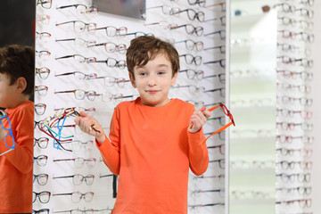 Poster -  choosing glasses at optics store
