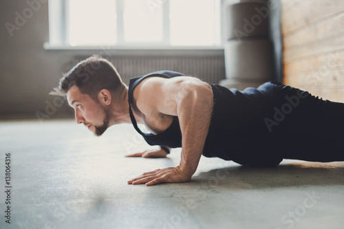 Fotografie, Obraz Young man fitness workout, push ups or plank