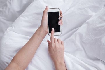 Poster - Closeup image of a teenager is searching information in network on mobile phone during free time. Young female student is revising photos on her cell telephone during break between lectures