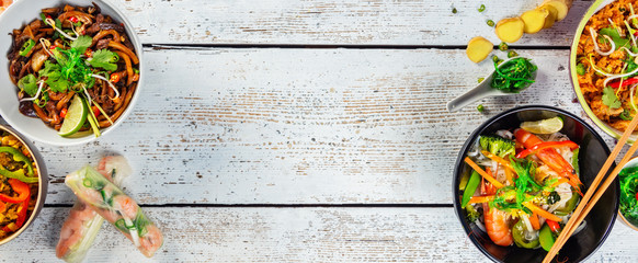 Asian food served on wooden table, top view, space for text