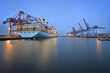 © Westend61 - Germany, Hamburg, Port of Hamburg, Container Terminal with ship in the morning