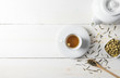 Hot tea with tea pot on white wood background