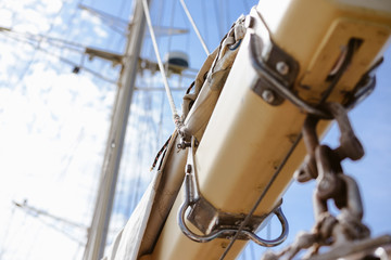 Blue sky and vintage 19th-century sailing ship mast, sunny background