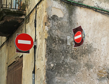 Red Signs "No Entry" Hanging On The Facade Of Old Building