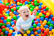 © famveldman - Child playing in ball pit on indoor playground