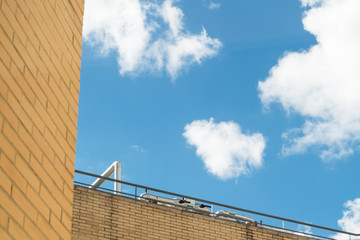 Brick building and blue sky with clouds.