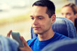 © Syda Productions - happy man sitting in travel bus with smartphone