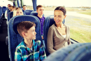 happy family riding in travel bus