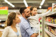 © Syda Productions - happy family buying food at grocery store