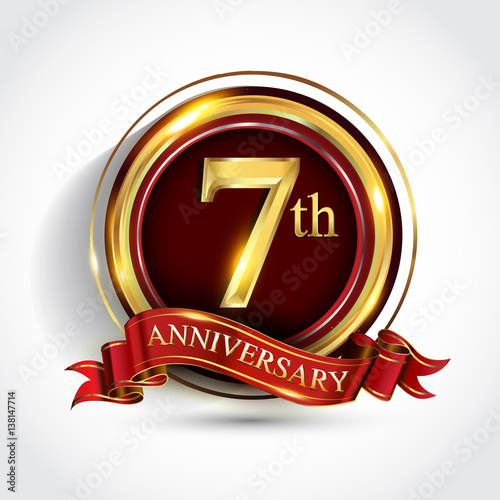 7th anniversary logo with ring and ribbon golden colored isolated on