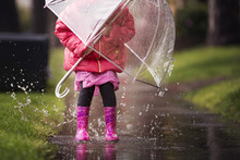 A Young Girl Is Playing In The Much Needed California Rain.