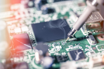 Electronic background: soldering of computer motherboard