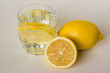 Lemons and glass of water with slices of lemon
