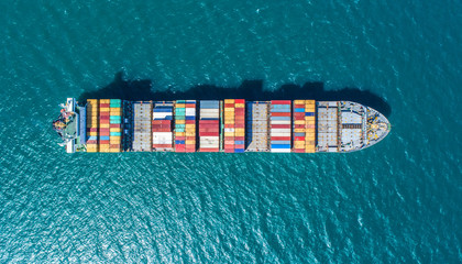 Wall Mural - container ship in import export and business logistic.By crane ,Trade Port , Shipping.cargo to harbor.Aerial view.Water transport.International.Shell Marine.Top view.